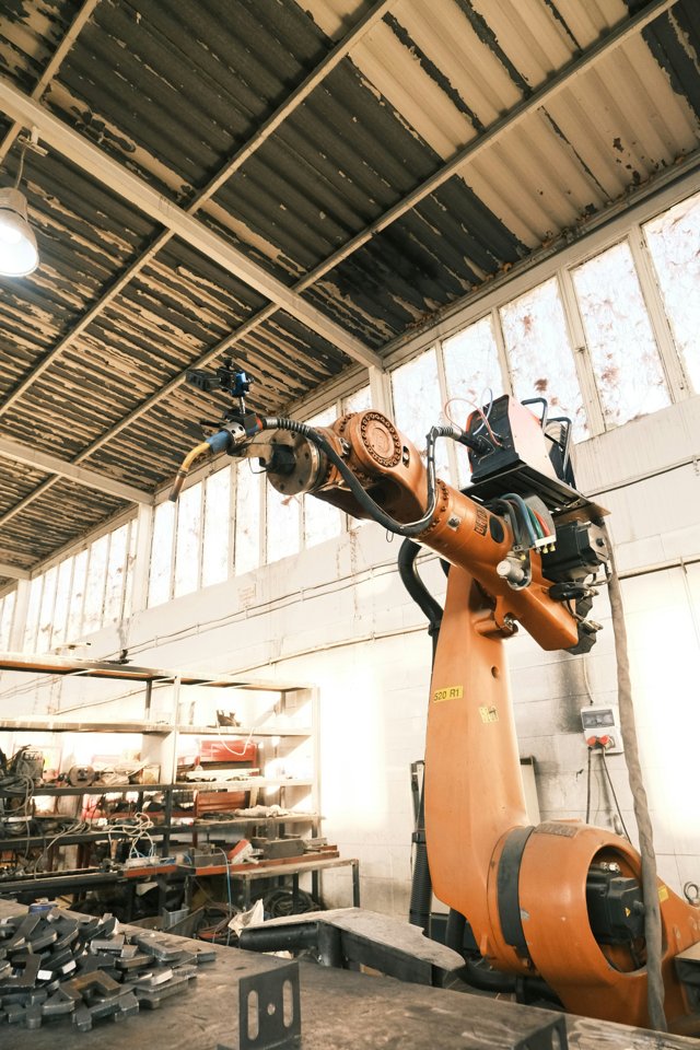 Robotic arm mechanical assembly in workshop, steel components, WEBUILDPRO Bangalore